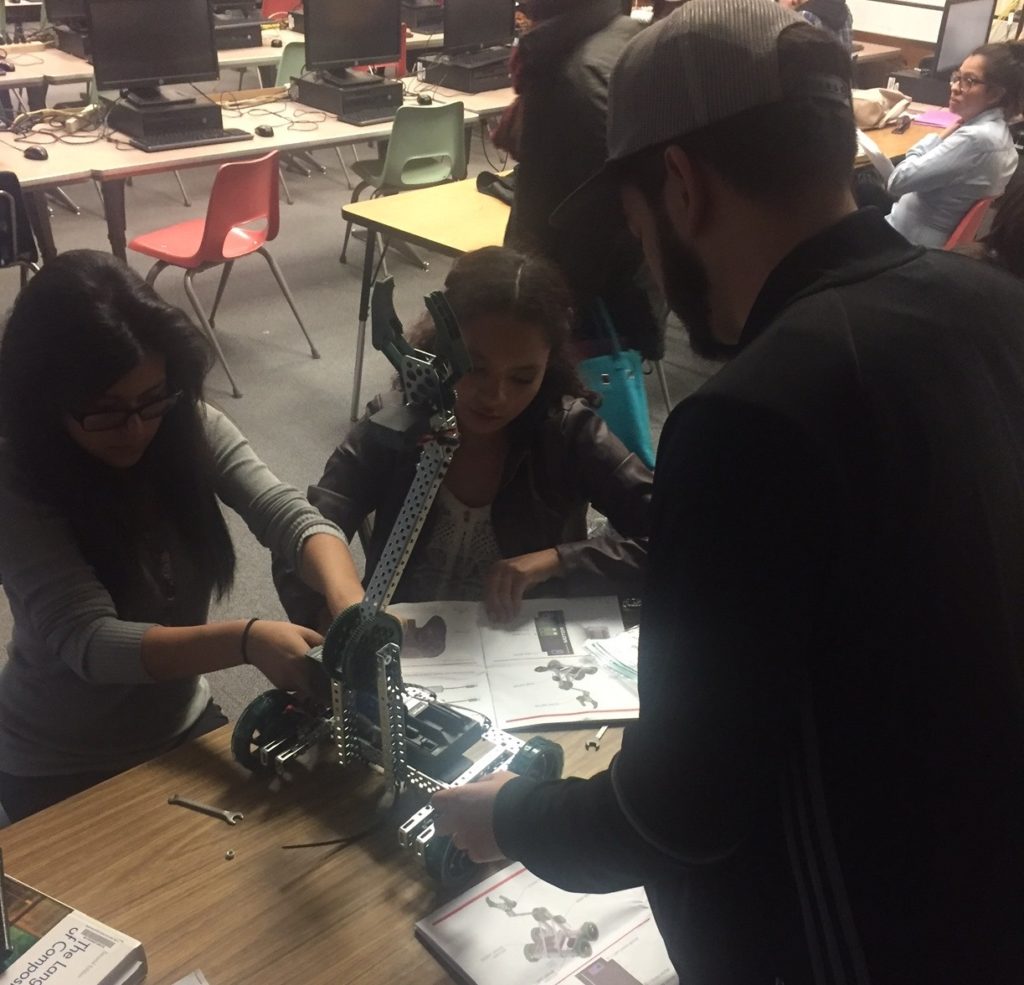 Students work together to construct a small robot