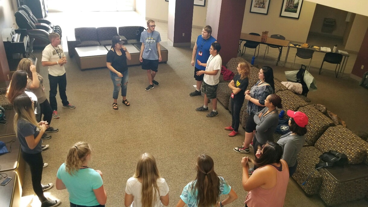 Students stand in a ring to participate in icebreaker activities